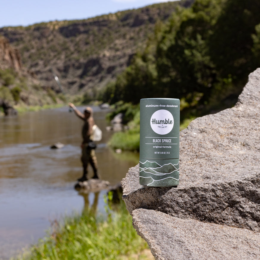 Black Spruce Paperboard Deodorant with man fishing in background