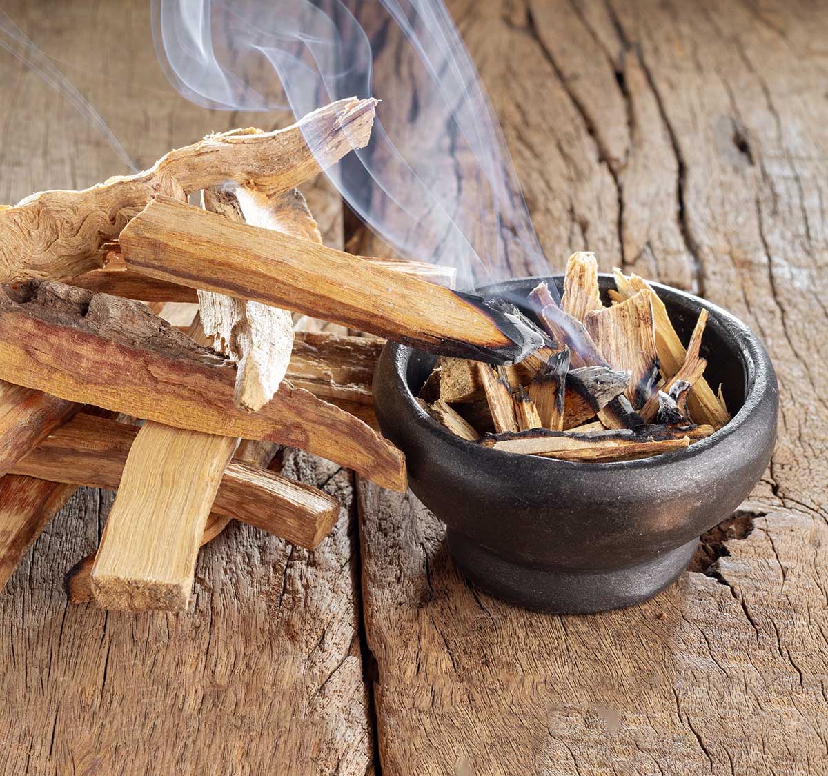 Palo Santo sticks burning in a small bowl