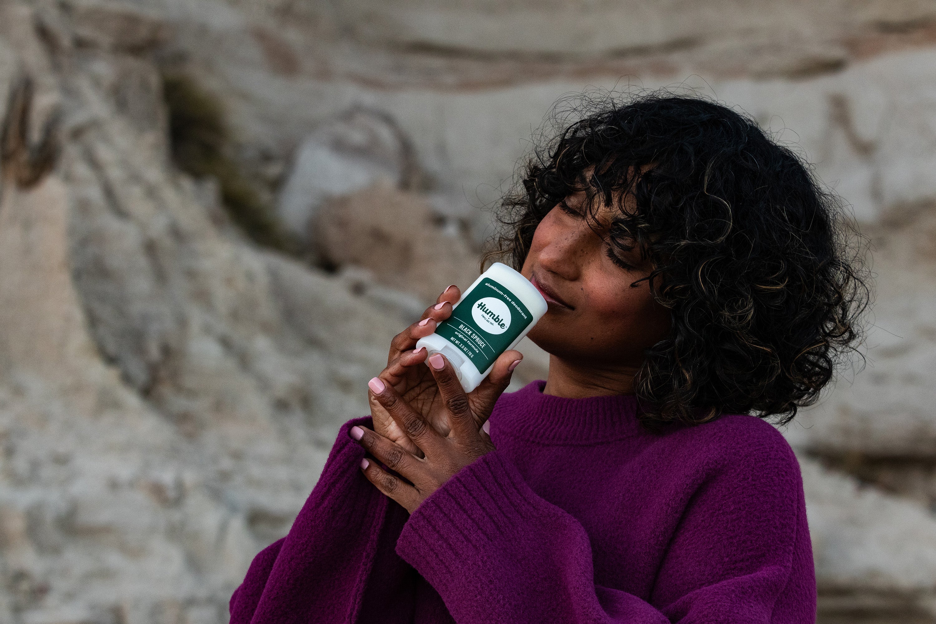 Woman smelling Black Spruce deodorant