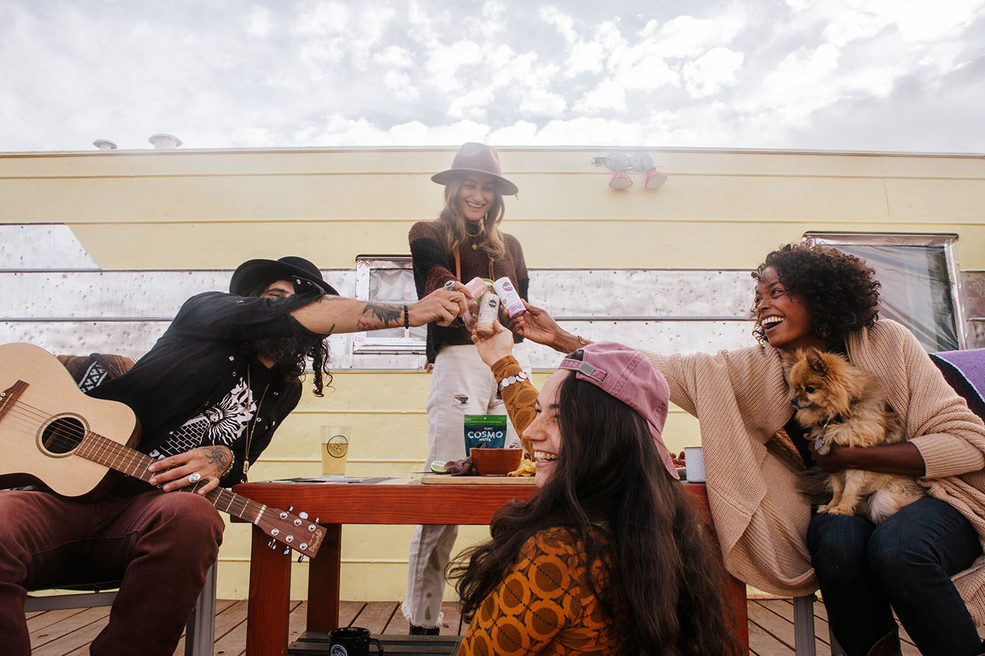 Four happy people toasting with paperboard deodorants