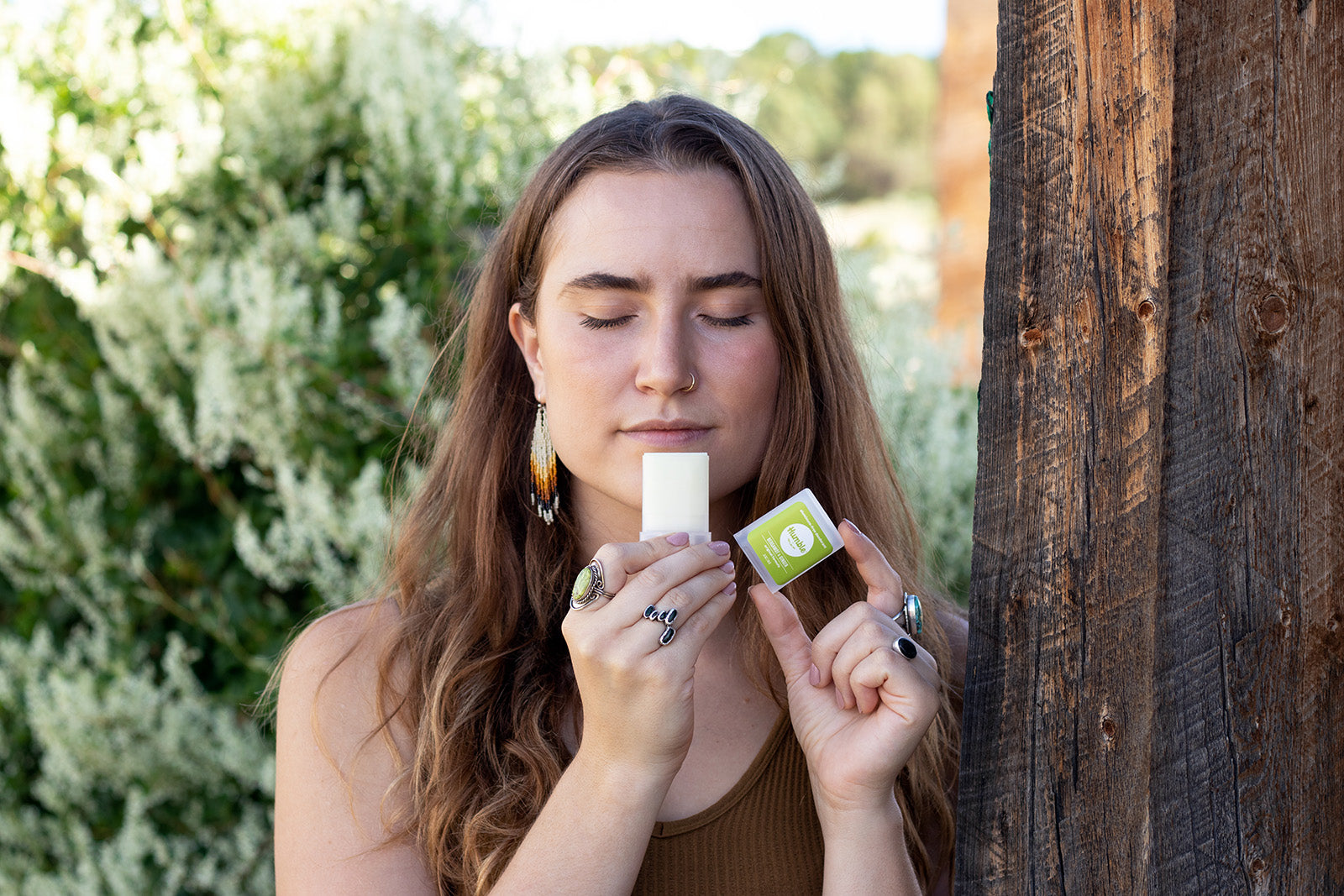 woman smelling a travel size deodorant