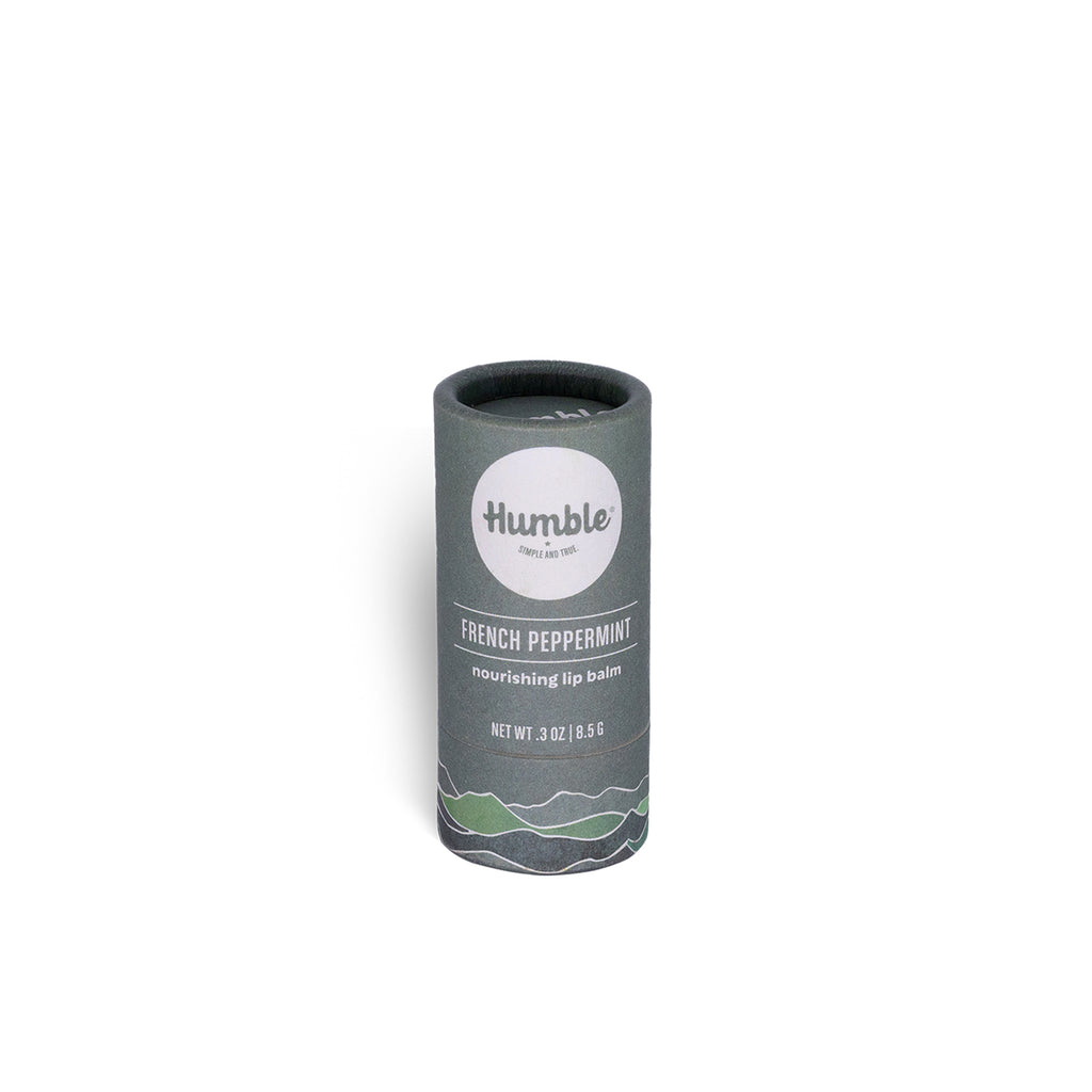 Lip balm container with 'Humble' branding on a white background