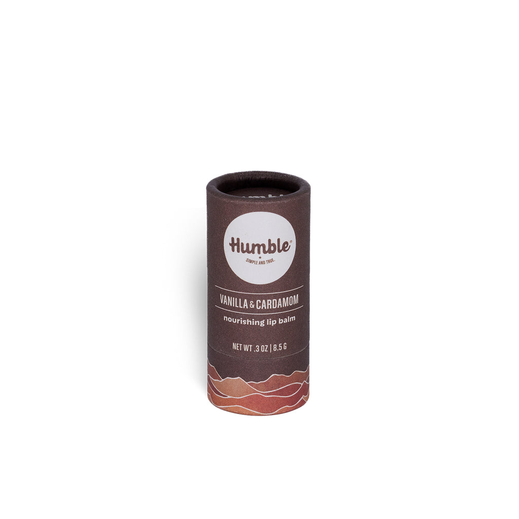 Front view of Vanilla & Cardamom plastic-free lip balm tube showing Humble logo and cardboard tube on white background