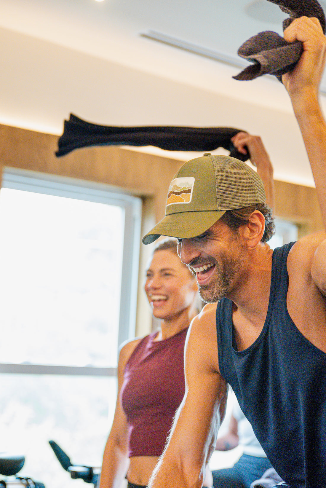 Man and woman exercising together in a gym setting