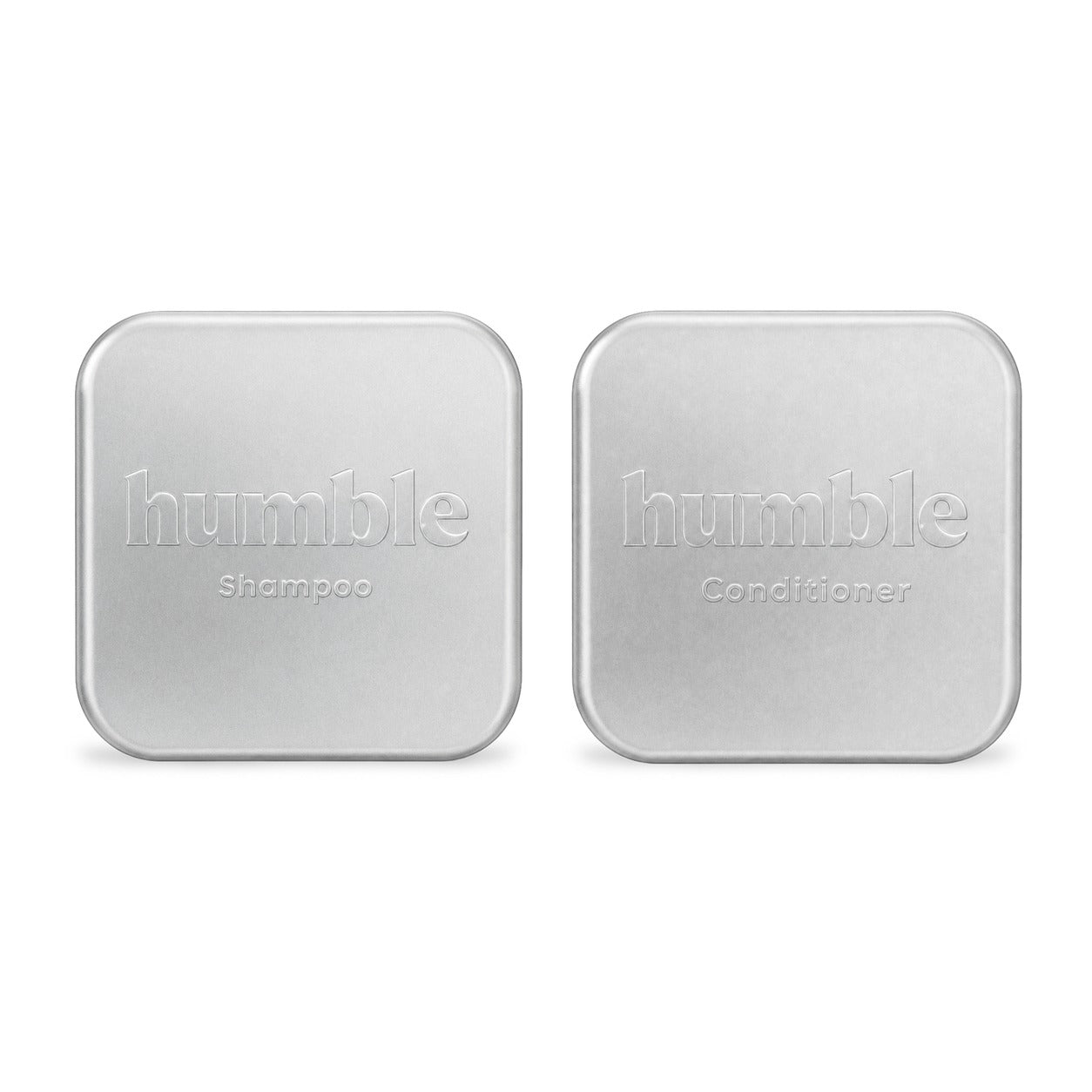 Humble Travel Tins, closed, anodized aluminum lids — humble Shampoo stamped into one, humble Conditioner into the other