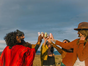 people holding up sticks of deodorant in the sun 