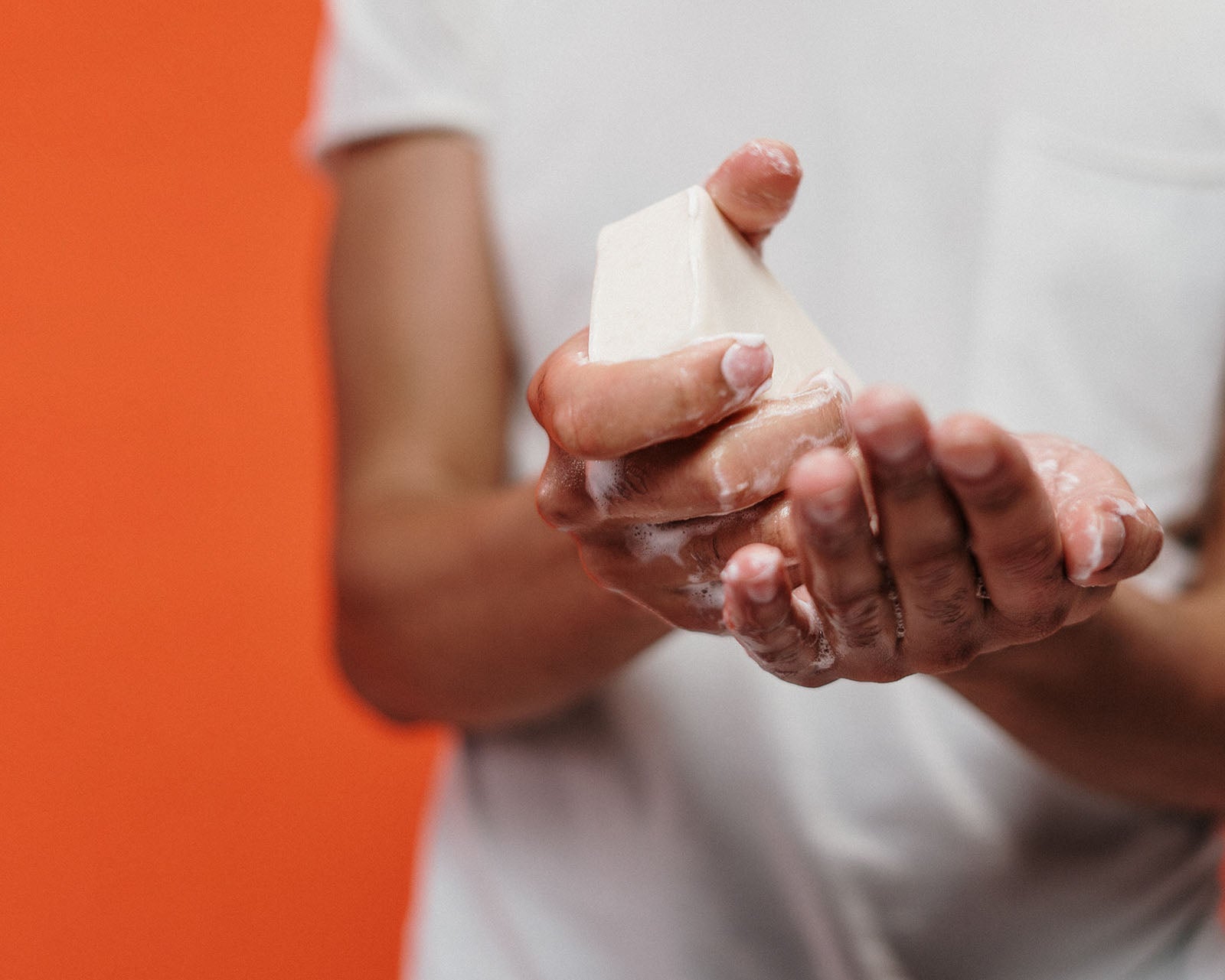 a person using bar soap to wash hands 